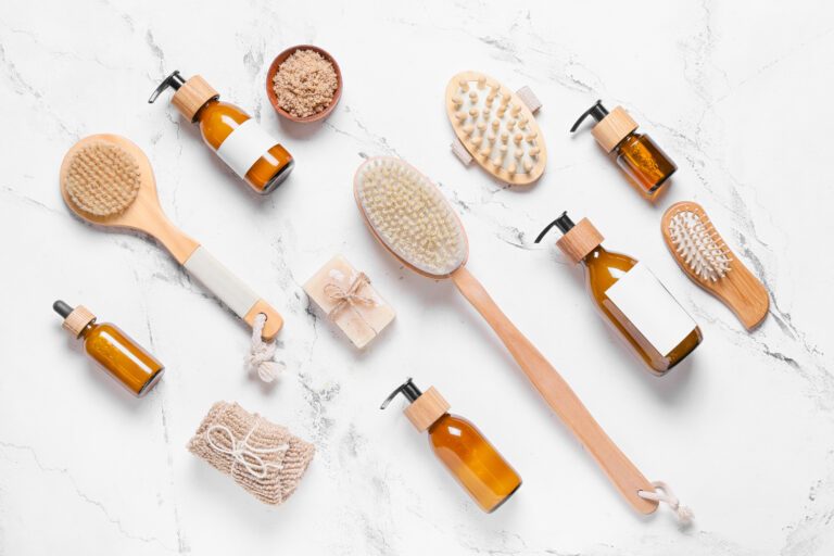 Composition with massage brushes and bath supplies on light background